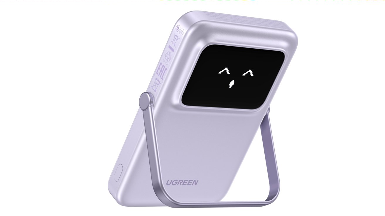 Новый магнитный аккумулятор Qi2 от Ugreen, установленный на подставке, с горящим смайликом на задней стороне