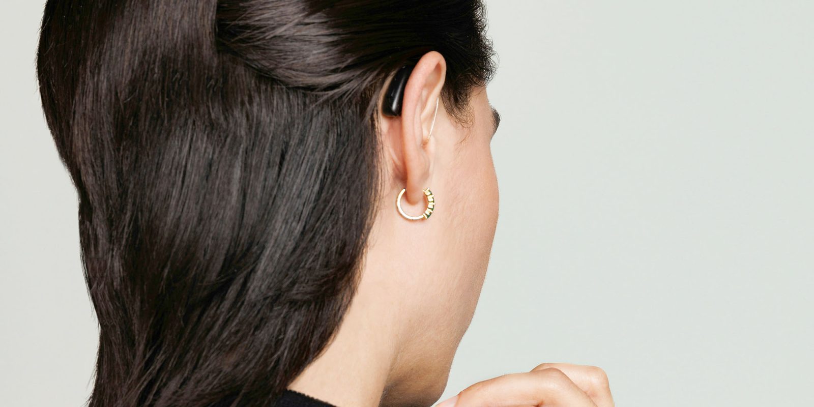 Использование AirPods Pro 2 в качестве слухового аппарата лучше, чем безрецептурное устройство | Крупный план женщины с обычным слуховым аппаратом